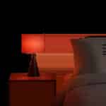 Une scène minimaliste met en valeur une lumière rouge douce dans une chambre moderne. L’ambiance évoque le confort visuel, la détente et l’usage du soir à la maison.