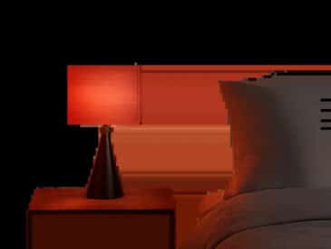Une scène minimaliste met en valeur une lumière rouge douce dans une chambre moderne. L’ambiance évoque le confort visuel, la détente et l’usage du soir à la maison.