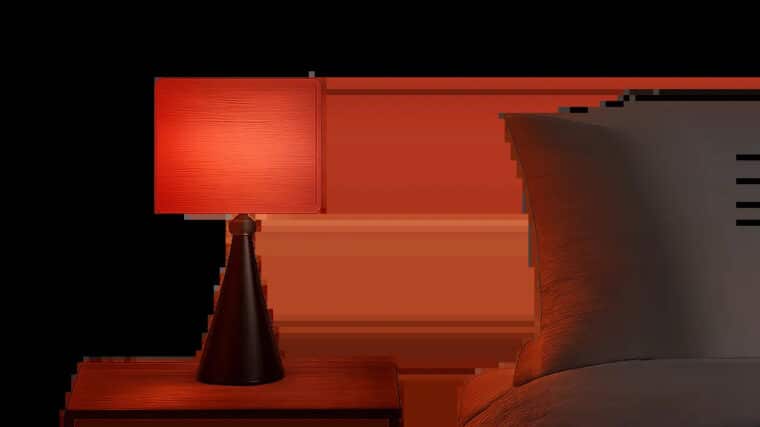 Une scène minimaliste met en valeur une lumière rouge douce dans une chambre moderne. L’ambiance évoque le confort visuel, la détente et l’usage du soir à la maison.