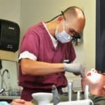 Dentist examining a patient's teeth in a clinic.
